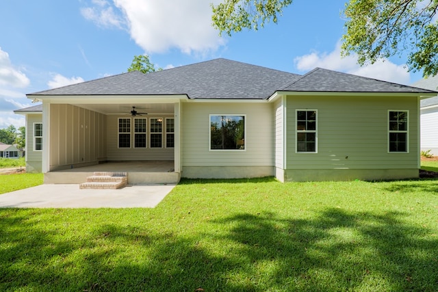 back of property with ceiling fan, a yard, and a patio