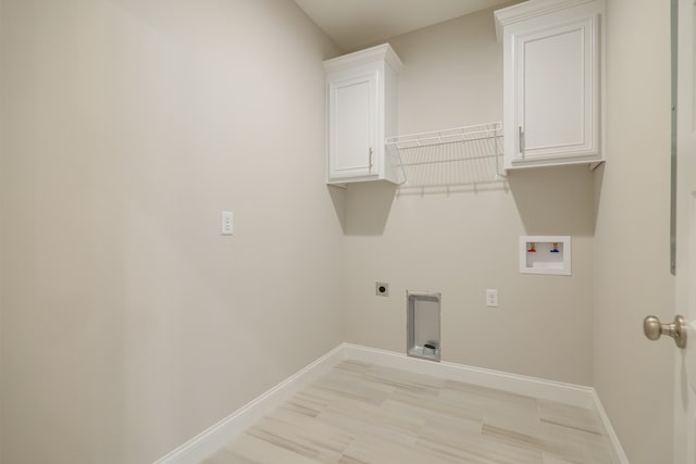 laundry room with electric dryer hookup, cabinets, and hookup for a washing machine