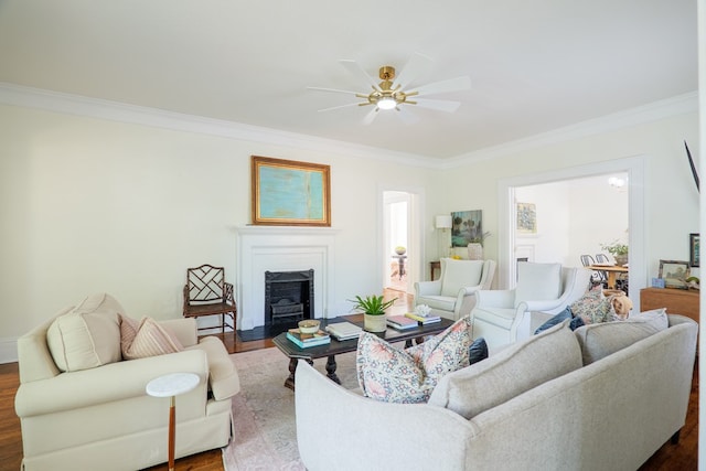 200 E College St, Valdosta, GA 31602 - living room featuring ornamental molding, dark wood-style flooring, ceiling fan, and a fireplace with flush hearth