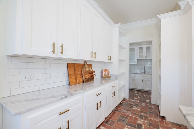 200 E College St, Valdosta, GA 31602 - bar featuring a sink, decorative backsplash, brick floor, and ornamental molding