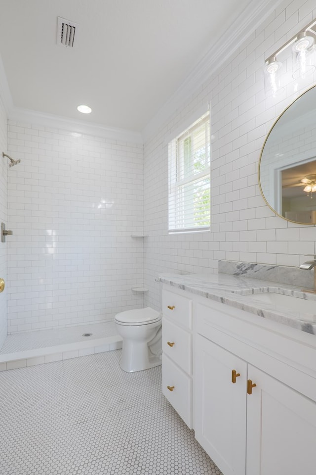 200 E College St, Valdosta, GA 31602 - bathroom with visible vents, crown molding, a tile shower, vanity, and toilet