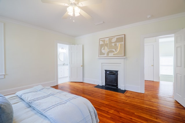 200 E College St, Valdosta, GA 31602 - bedroom featuring crown molding, a ceiling fan, baseboards, wood finished floors, and visible vents