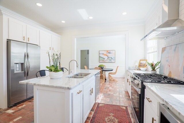 200 E College St, Valdosta, GA 31602 - kitchen with ornamental molding, wall chimney exhaust hood, brick floor, a sink, and appliances with stainless steel finishes