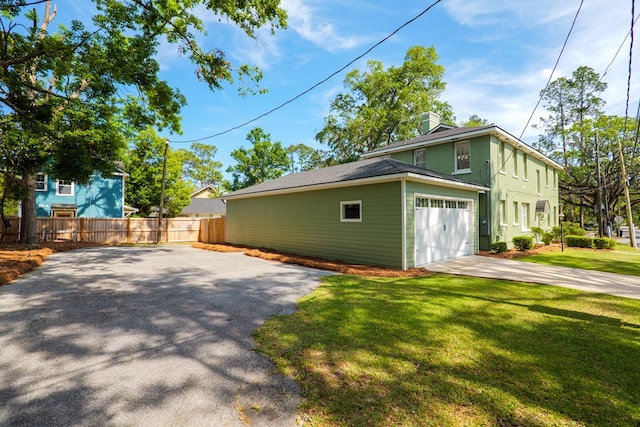 200 E College St, Valdosta, GA 31602 - view of property exterior with driveway, a chimney, a lawn, a garage, and fence