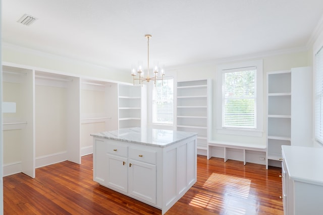 200 E College St, Valdosta, GA 31602 - walk in closet featuring visible vents, dark wood-style flooring, and an inviting chandelier