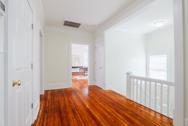 200 E College St, Valdosta, GA 31602 - hall featuring visible vents, ornamental molding, hardwood / wood-style floors, baseboards, and an upstairs landing