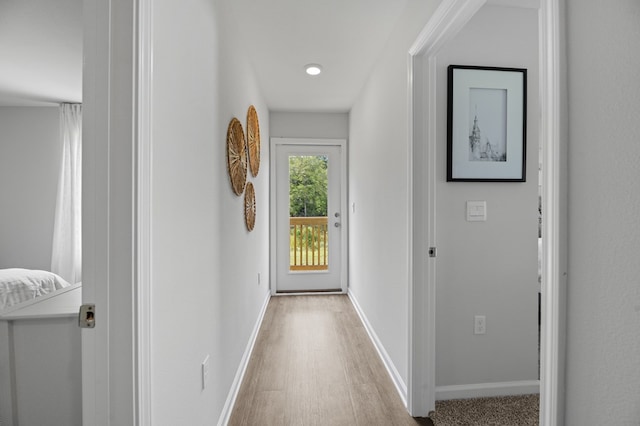 entryway with baseboards and wood finished floors