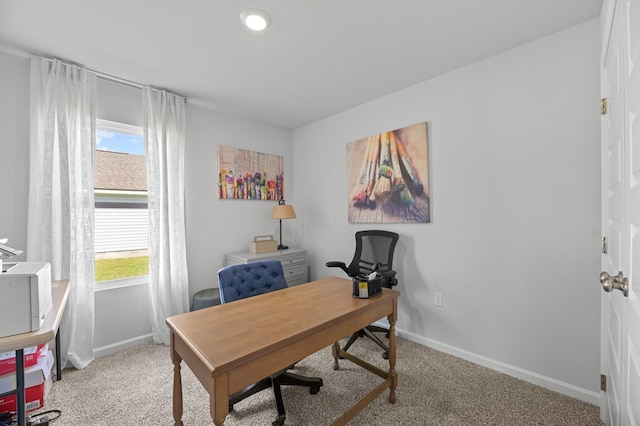 home office featuring light carpet and baseboards