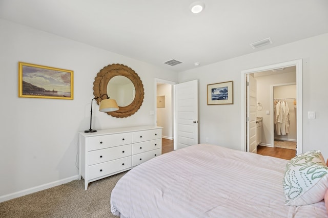 bedroom with carpet floors, baseboards, and visible vents