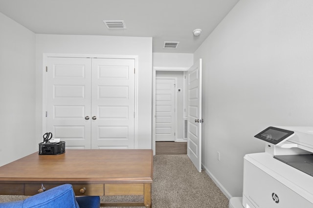 office area with baseboards, visible vents, washer / clothes dryer, and carpet flooring