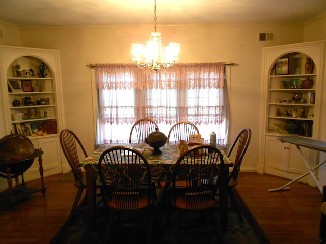 dining space featuring a notable chandelier, crown molding, visible vents, and dark wood-style flooring