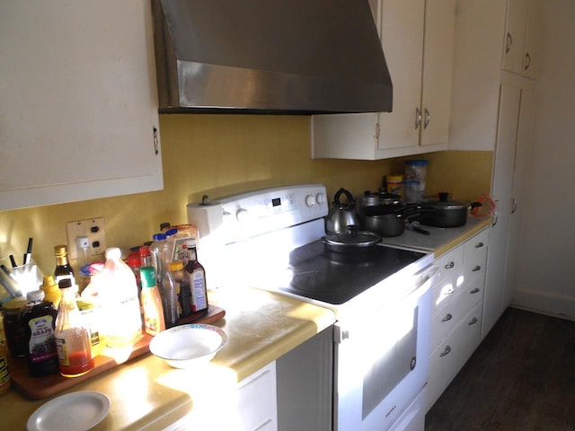 kitchen with white cabinetry, light countertops, white range with electric cooktop, and exhaust hood