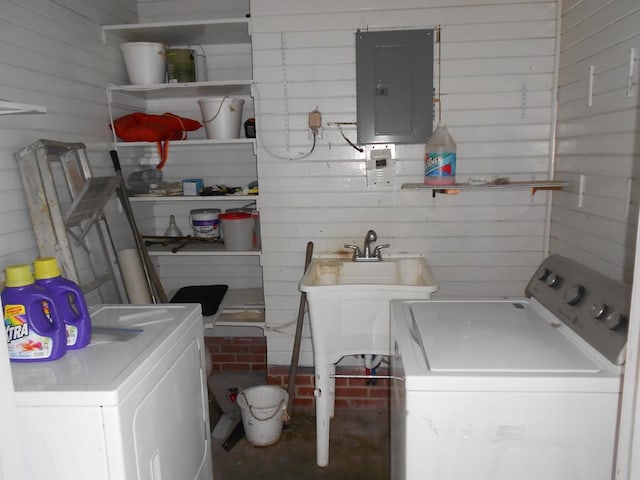 washroom with laundry area, electric panel, a sink, and independent washer and dryer