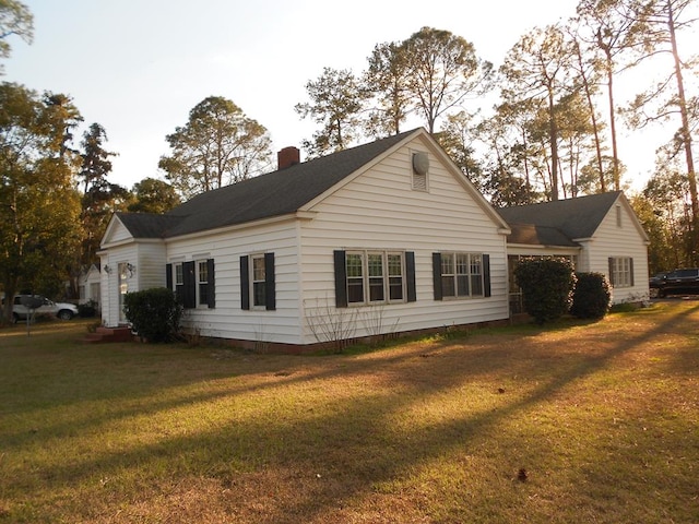 view of property exterior featuring a lawn and a chimney