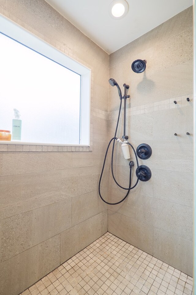 full bathroom with a tile shower