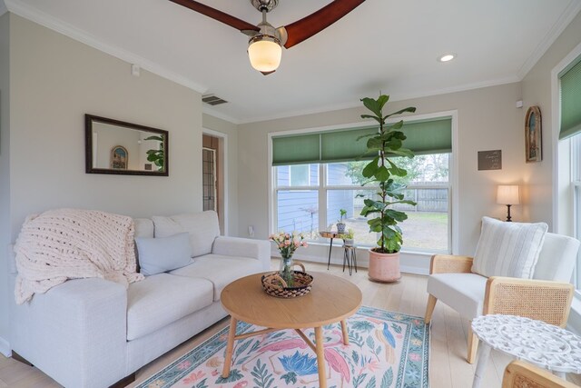living area featuring recessed lighting, wood finished floors, visible vents, and ornamental molding