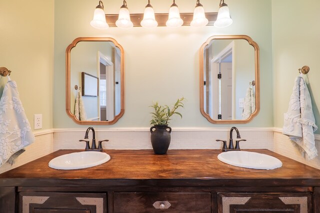 full bath with a sink and double vanity