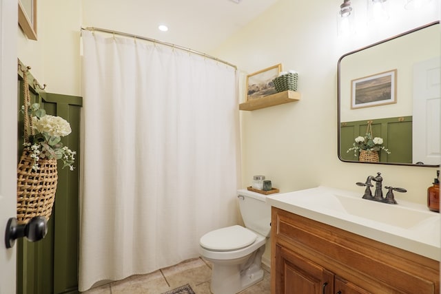 bathroom featuring tile patterned flooring, curtained shower, toilet, and vanity