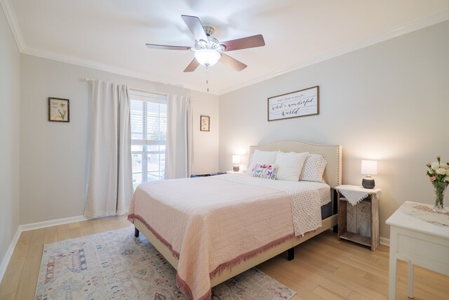 bedroom with a ceiling fan, light wood-style floors, baseboards, and ornamental molding