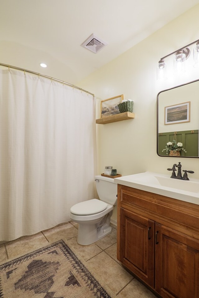 full bath featuring visible vents, toilet, vanity, and tile patterned flooring