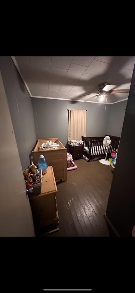 bedroom with ceiling fan and dark hardwood / wood-style flooring