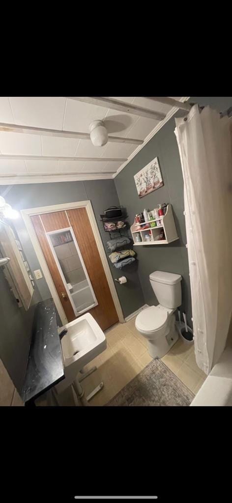 bathroom with tile patterned floors and toilet