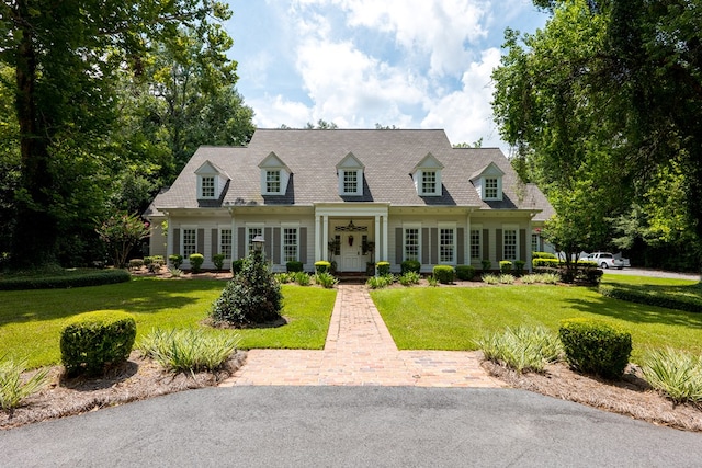 new england style home with a front lawn