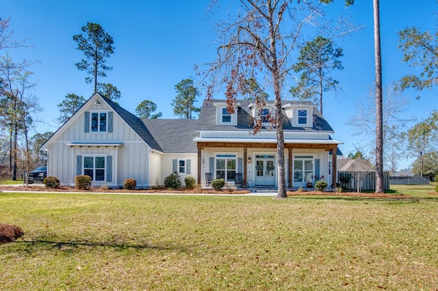 view of front facade with a porch, board and batten siding, a front yard, and fence