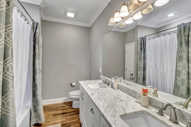 full bathroom with wood finished floors, a sink, toilet, and crown molding