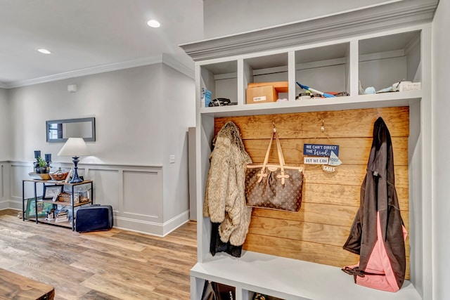 mudroom featuring recessed lighting, a decorative wall, ornamental molding, wainscoting, and wood finished floors