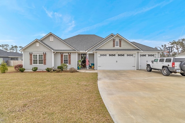 ranch-style home with driveway, a shingled roof, a garage, and a front yard