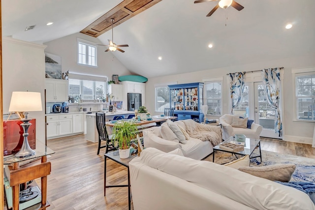 living area with a ceiling fan, light wood-type flooring, high vaulted ceiling, and recessed lighting