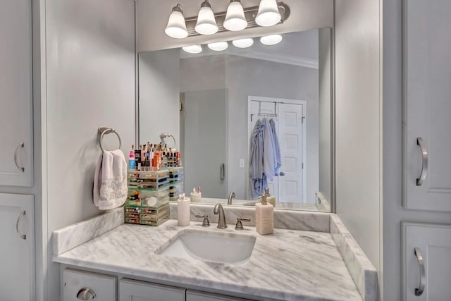 bathroom with crown molding and vanity