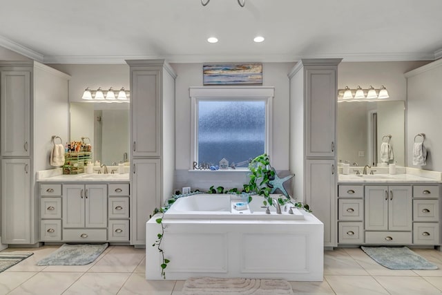 bathroom with two vanities, crown molding, and a garden tub