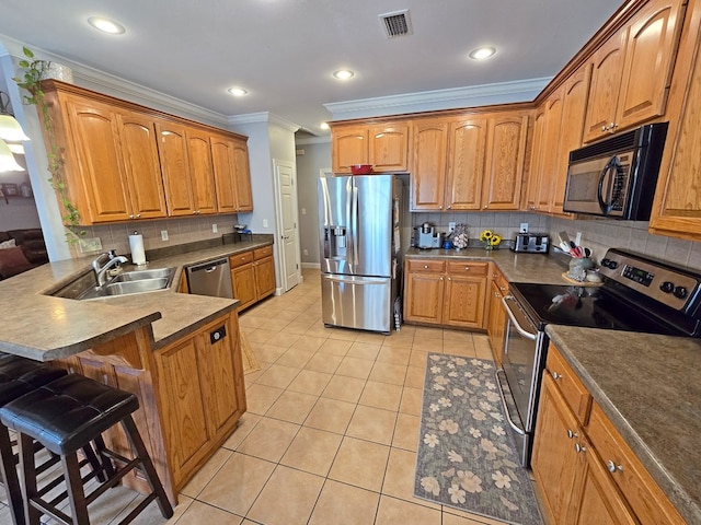 3265 Summer Meadows Rd, Valdosta, GA 31601 - kitchen featuring stainless steel appliances, a kitchen bar, a peninsula, light tile patterned flooring, and a sink
