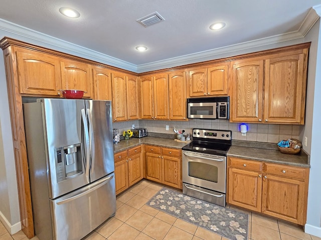 3265 Summer Meadows Rd, Valdosta, GA 31601 - kitchen with appliances with stainless steel finishes, dark countertops, crown molding, light tile patterned floors, and tasteful backsplash