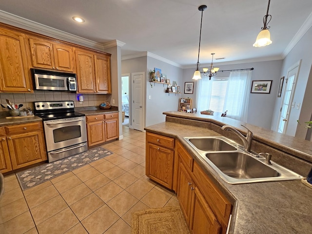 3265 Summer Meadows Rd, Valdosta, GA 31601 - kitchen with stainless steel appliances, a sink, ornamental molding, pendant lighting, and dark countertops