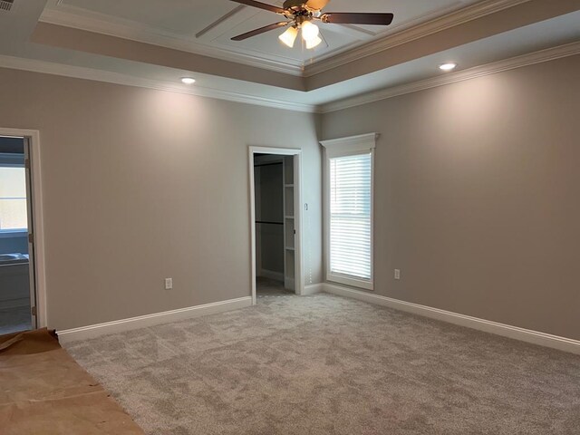 unfurnished bedroom featuring multiple windows, crown molding, ceiling fan, and light carpet