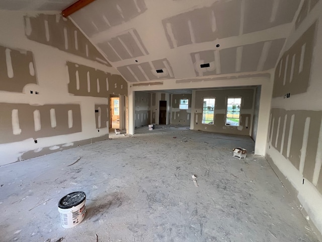 interior space with vaulted ceiling with beams