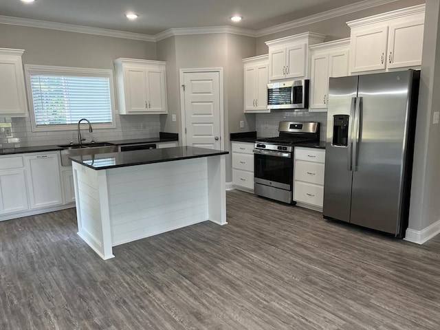 kitchen with tasteful backsplash, white cabinetry, dark hardwood / wood-style flooring, and stainless steel appliances