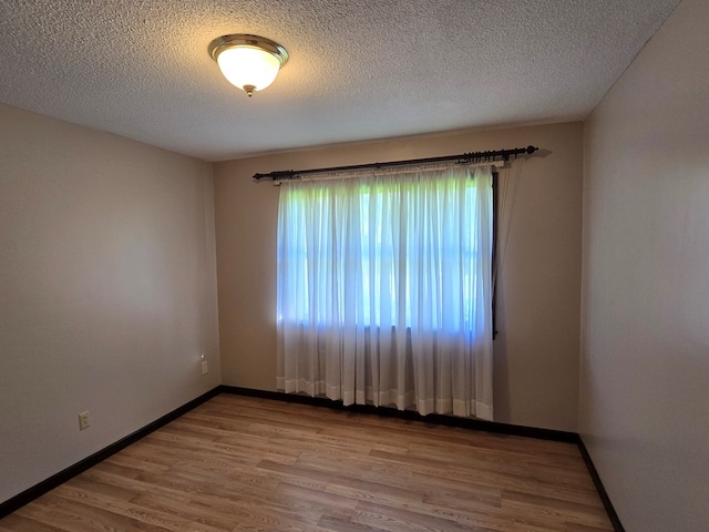 617 Ledgedale Cir, Valdosta, GA 31602 - spare room with wood finished floors and a textured ceiling
