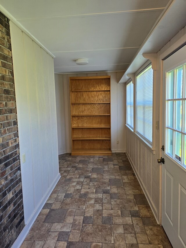 617 Ledgedale Cir, Valdosta, GA 31602 - hallway featuring healthy amount of natural light, built in features, and wooden walls