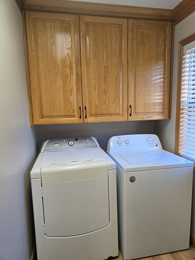 617 Ledgedale Cir, Valdosta, GA 31602 - laundry area with independent washer and dryer and cabinet space