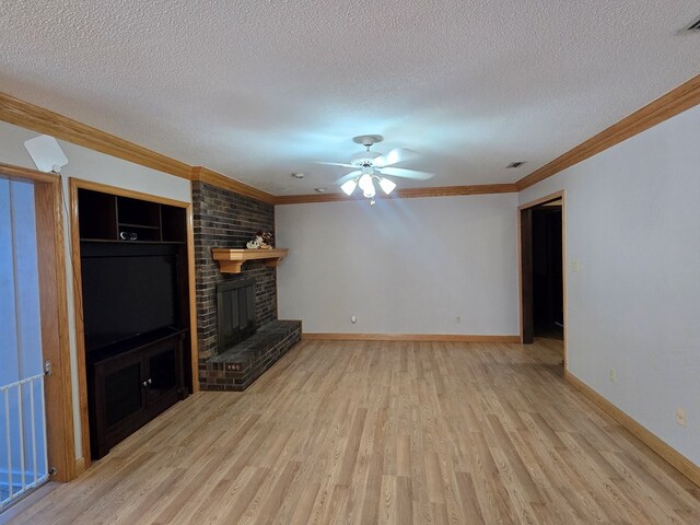 617 Ledgedale Cir, Valdosta, GA 31602 - unfurnished living room featuring crown molding, light wood-style floors, a textured ceiling, a brick fireplace, and a ceiling fan