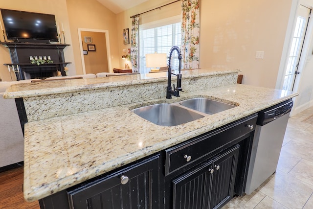 4773 Pawnee Dr, Hahira, GA 31632 - kitchen featuring dark cabinetry, dishwasher, a sink, plenty of natural light, and vaulted ceiling