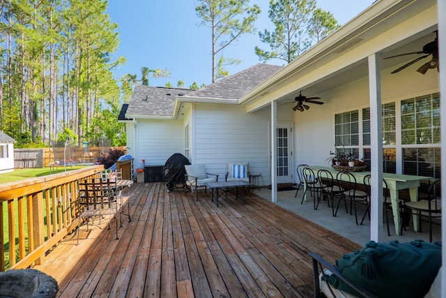 4773 Pawnee Dr, Hahira, GA 31632 - wooden terrace featuring a trampoline, ceiling fan, and outdoor dining area