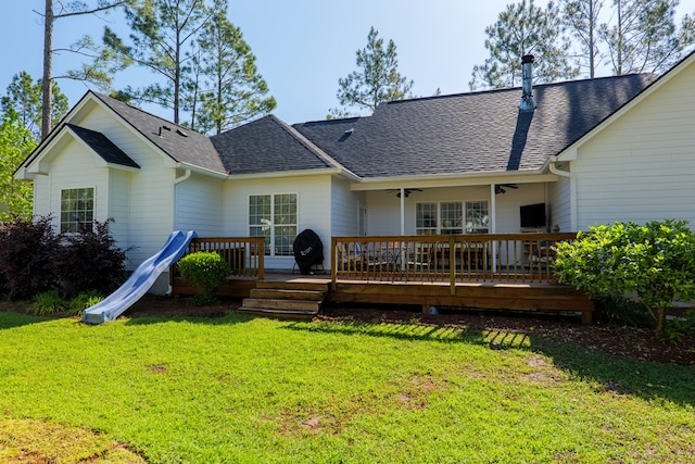 4773 Pawnee Dr, Hahira, GA 31632 - rear view of house featuring roof with shingles, a yard, and a deck