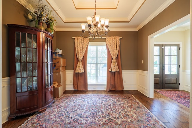 4773 Pawnee Dr, Hahira, GA 31632 - foyer entrance with a tray ceiling, french doors, hardwood / wood-style flooring, a chandelier, and a wainscoted wall