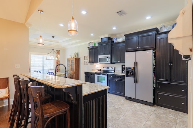 4773 Pawnee Dr, Hahira, GA 31632 - kitchen with appliances with stainless steel finishes, ornamental molding, a breakfast bar area, light stone counters, and hanging light fixtures