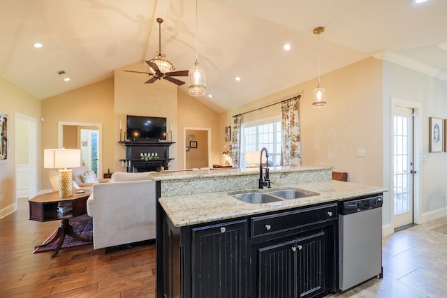 4773 Pawnee Dr, Hahira, GA 31632 - kitchen with dishwasher, dark cabinetry, a sink, open floor plan, and ceiling fan